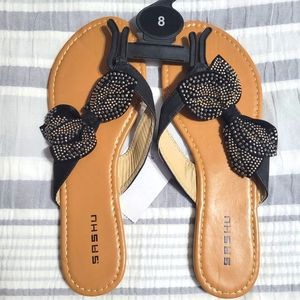 NWT shoes. Sashu 8. Tan sandals with black bows and gold gems.